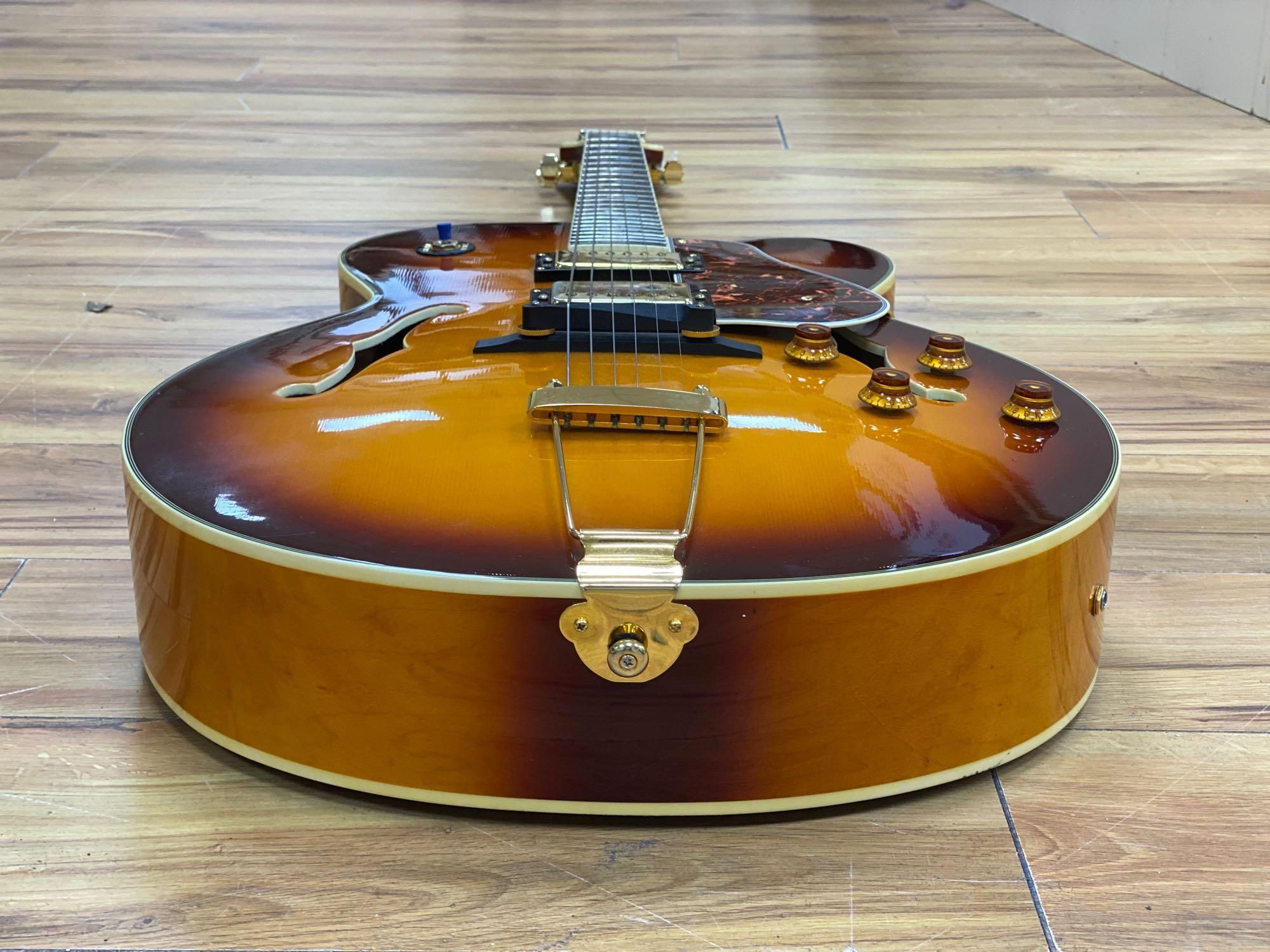 An Aria Career electric acoustic and jazz guitar, in soft case